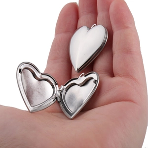 Macro shot of open heart-shaped 316L stainless steel locket showing inner compartment
