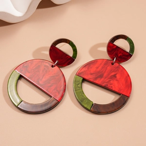 Detailed view of large acrylic geometric circle earrings with marble texture and silver pins