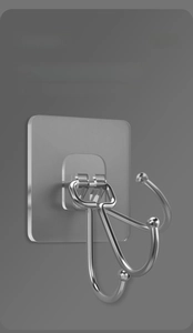 Detail of 180-degree rotating silver metal hook on transparent self-adhesive base