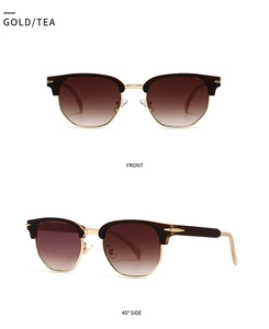 Close-up of gold clubmaster sunglasses with tea gradient lenses and metal frames