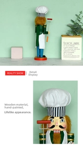 Detail of wooden chef nutcracker showing hand-painted green uniform and chef hat details