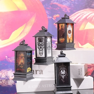 Set of four black Halloween lanterns with skull and pumpkin patterns on vintage books