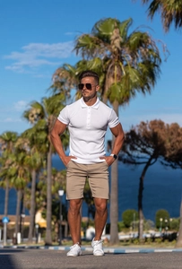 Outdoor shot of men's white vertical striped slim fit short sleeve polo shirt and khaki shorts