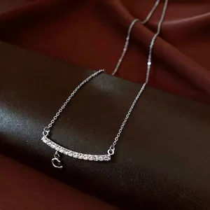 Elegant silver C-pendant necklace with zircon-encrusted bar on premium leather background