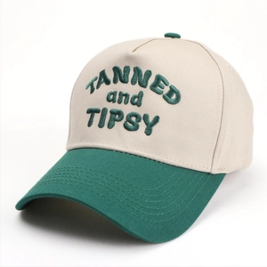 Close-up of TANNED and TIPSY 3D embroidery on two-tone cotton baseball cap