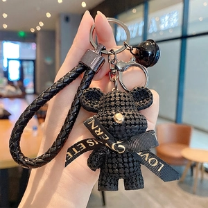 Cool black resin bear keychain with woven texture ribbon bow and braided leather strap