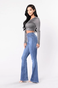 Detail view of high-waisted flare jeans with five-button closure and slim fit design