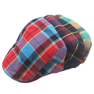 Detailed view of colorful plaid ivy caps in red, blue, and green tartan patterns
