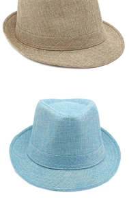 Detailed cross-weave texture of khaki and light blue fedoras in a clean flat lay view