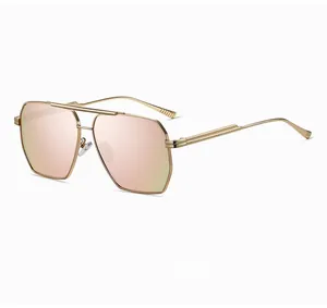 Detail of aviator polarized sunglasses with gold double bridge and pink gradient lenses
