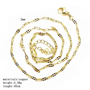 Detail view of 2mm golden copper link chain showing flat rings and spiral layout