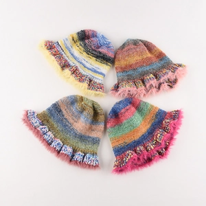 Colorful oil painting style knitted bucket hat with faux fur trim for winter warmth