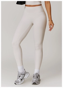 Detailed close-up of matte off-white high-waist yoga leggings with seamless athletic fit