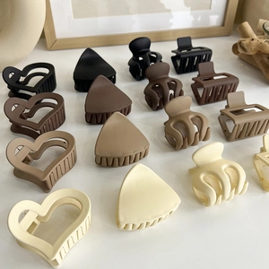 Elegant matte milk tea colored hair claw clips in geometric shapes for women