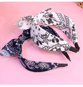 Detail of paisley print knot headbands in navy and white fabric with rabbit ear design