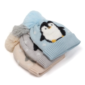 Cozy penguin jacquard knit hats with faux fur pom-poms in light blue, gray, and beige