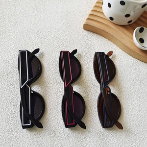 Retro cat-eye Y2K sunglasses in white, pink, and blue with stylish wide geometric temples
