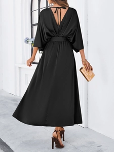 Elegant back view of black satin maxi dress with V-back design and tie details