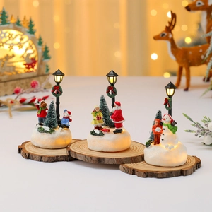 Lighted Christmas resin miniature scene with Santa, snowman and warm glowing LED street lights