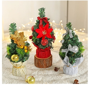 Close-up of three mini tabletop Christmas trees with gold, red and silver holiday decorations