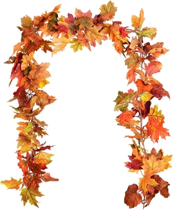 Detail of autumn maple leaf garland with vibrant orange and red foliage on white background