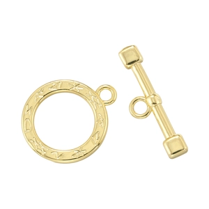 Macro detail of gold toggle clasp with engraved rune symbols for DIY jewelry making
