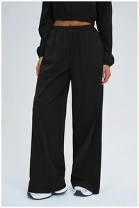 Full view of black sun protection sportswear set with cropped top and wide-leg trousers