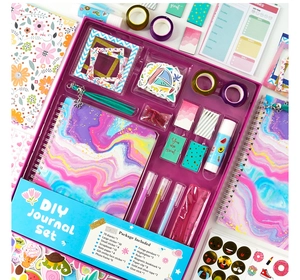 Detailed view of DIY Journal Set including purple glitter notebook and stationery accessories