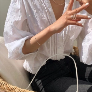 Detailed view of S925 sterling silver olive bead bracelet styled on a female model