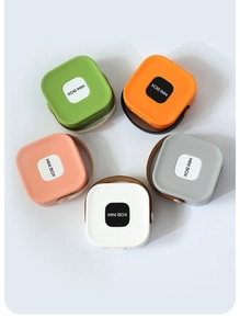 Overhead view of five colorful mini storage boxes with brown leather carry straps