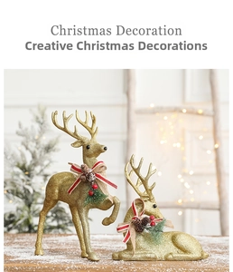 Close-up of golden reindeer statues with festive red bows and pine accents on snowy wood
