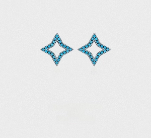 Macro detail of silver four-pointed star stud earrings with inlaid turquoise stones