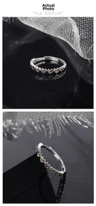 Macro shot of S925 sterling silver ring with colorful zircon stones and wave design