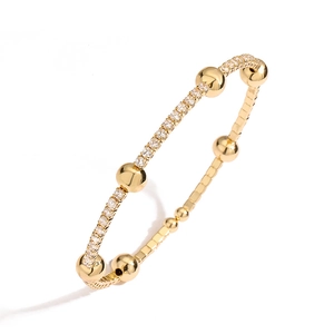 Adjustable gold plated copper bangle with sparkling zircons and beads in a minimalist style