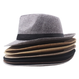 Stack of colorful straw fedora hats with black ribbons for sun protection