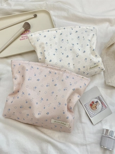 Floral makeup bags in cream and pink canvas with delicate blue flower patterns