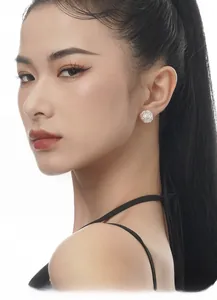 Close-up of S925 silver freshwater pearl stud earring with textured floral design