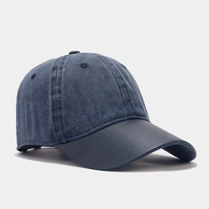 Retro washed denim baseball cap with navy blue leather brim and a soft top design