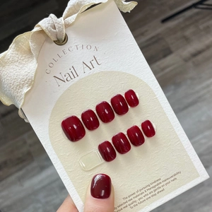 Handmade burgundy press-on nails set with glossy finish on elegant display card