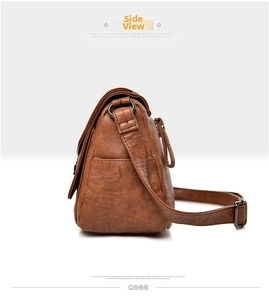 Side view of retro brown crossbody bag showing textured leather and metal hardware detail