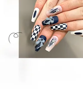Detailed view of blue checkered press-on nails with 3D bows and pearl accents