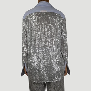Back view of a sequined long sleeve shirt with blue and white striped fabric accents