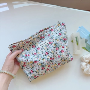 Detail shot of a floral cotton canvas pouch with rose prints and simple wish label