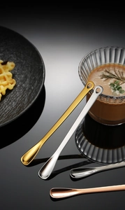 Three long-handled stainless steel spoons in gold, silver and rose gold finishes