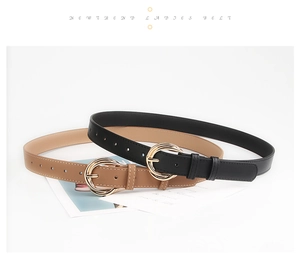 Detail of fashion belts in black and camel colors with golden double ring metal buckles