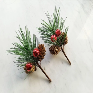 Christmas pine cones with green needles and red metal bells for holiday wreath DIY decoration