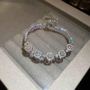 Macro detail of the silver emerald cut gemstone bracelet with pavé diamonds on velvet