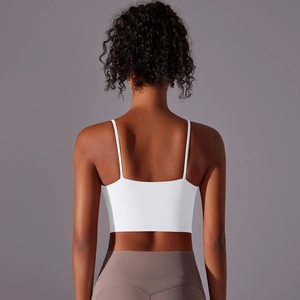 Detail view of white yoga sports bra with thin straps and a cross back design