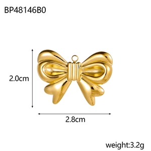 Macro view of gold plated bow pendant showing 2.8cm size dimensions and 3.2g weight