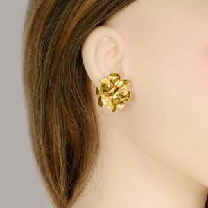Detail of 18k gold plated stainless steel floral earrings showing pleated metal texture